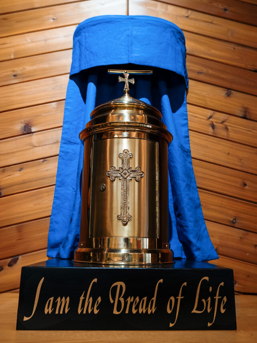 Gold tabernacle with inscription “I am the Bread of Life” in Our Lady of Fatima Church, Minden, Ontario – Catholic church altar tabernacle draped in blue cloth.