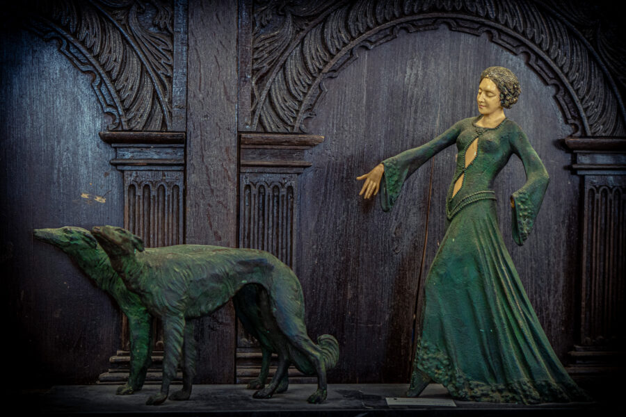 Art deco style sculpture of a woman in a flowing dress with two hounds at Castle Antiques Haliburton Ontario.