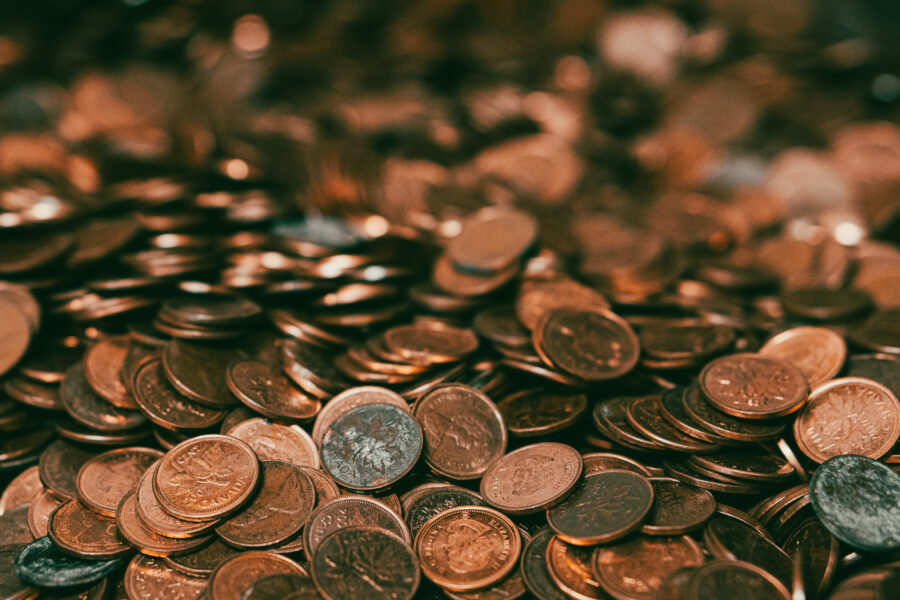 Collection of old copper Canadian one-cent coins featuring maple leaf design, available at Castle Antiques Haliburton Ontario.