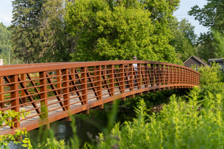 Rust-colored pedestrian bridge on the Minden River Walk over the Gull River, Minden Ontario