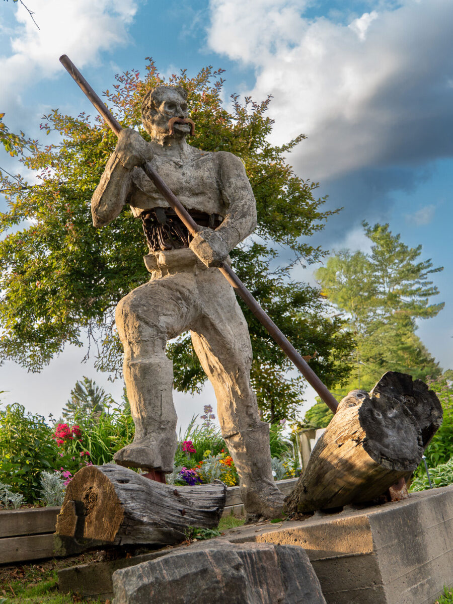 Large statue of a log driver holding a pike pole, Minden Ontario