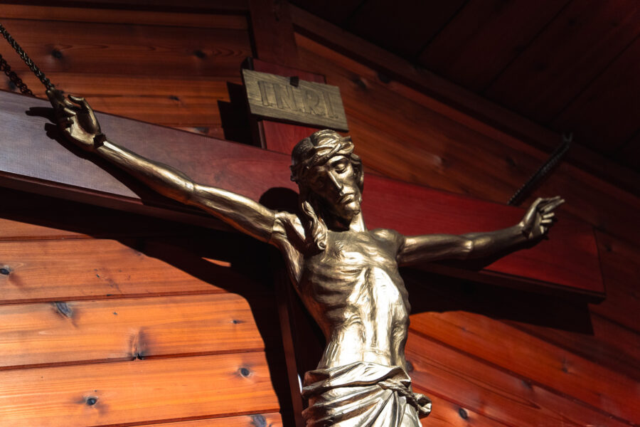 Close-up of gold-toned corpus of Jesus Christ on a wooden crucifix at Our Lady of Fatima Church, Minden, Ontario.
