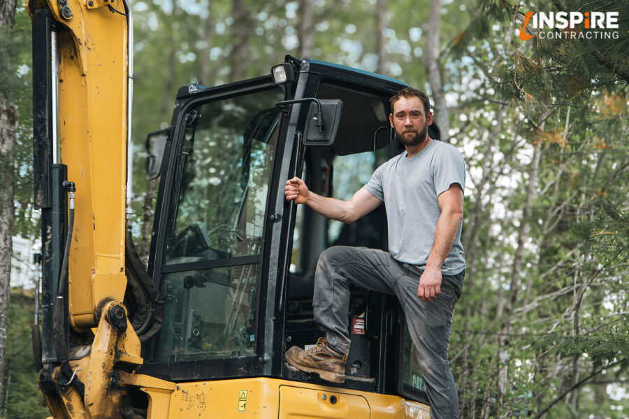 Tyler Hall from Inspire Contracting operating a compact excavator while grading a Haliburton job site