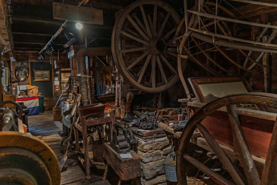 Westport Ontario museum exhibit with wagon wheels and antique farm tools”