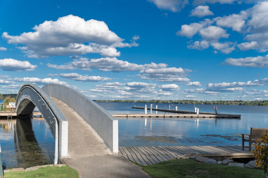 Arched pedestrian bridge over marina at Rideau Lake in Westport Ontario